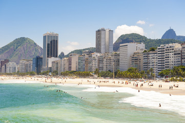 Obraz premium Scenic view of Copacabana Beach shore from the Leme end with the city skyline of Rio de Janeiro, Brazil