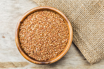 Bowl with Buckwheat on a wooden background