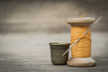 still life of spools of thread on a wooden background