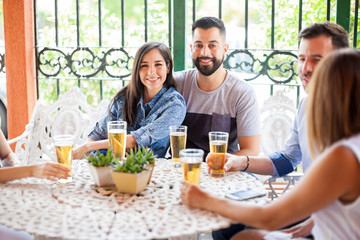 Cute young couple hanging out with friends