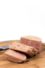 Luncheon meat on the wooden board isolated on white background