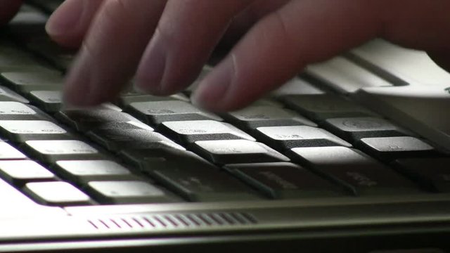 Fast typer using keyboard to input data into a laptop.