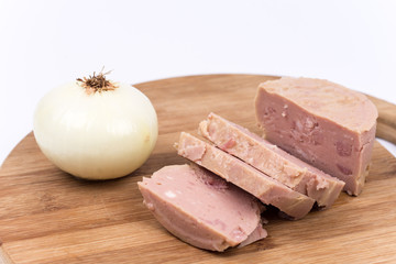 Luncheon meat and onion on the wooden board isolated on white ba
