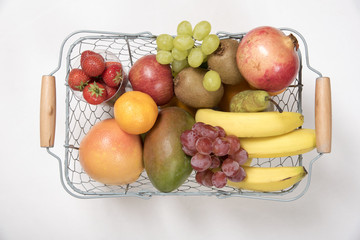 FRESH FRUIT IN A SHOPPING BASKET AND A SHOPPING LIST
