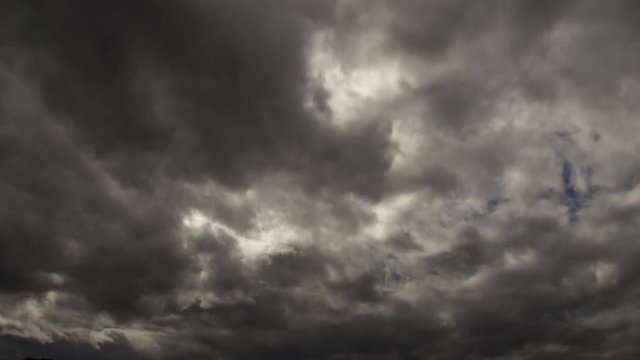 Time-lapse dark clouds rush toward the camera