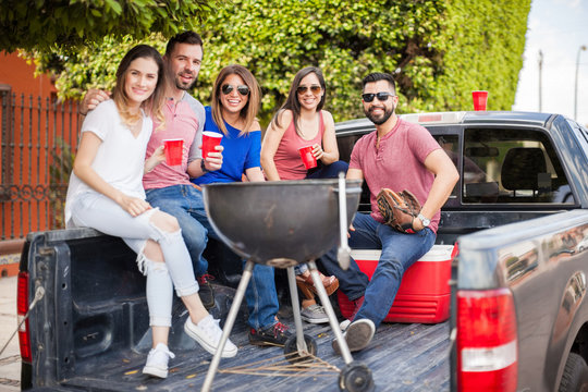 Friends Hanging Out On The Back Of A Pick Up Truck