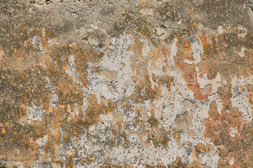 Dirty wall with peeling plater and rusty stains