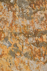 Dirty wall with peeling plater and rusty stains