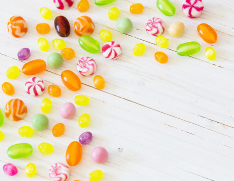 variety of candies on a wooden background