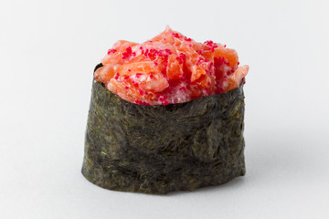 Sushi spicy with fish, sauce and tobiko caviar on a white background