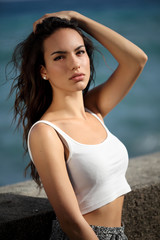 Fototapeta na wymiar Beautiful young woman outdoors portrait near the sea