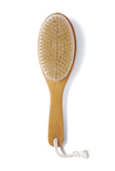 A wooden body massage brush isolated on a white background