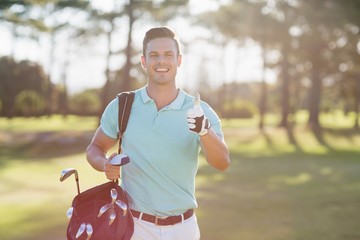 Portrait of smiling golfer man showing thumbs up 