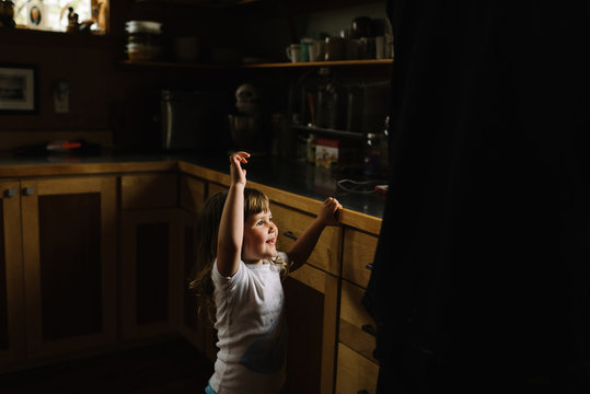 Smiling little girl standing in the kitchen