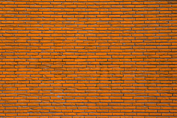 Orangefarbene Wand aus Ziegelsteinen ergibt Muster