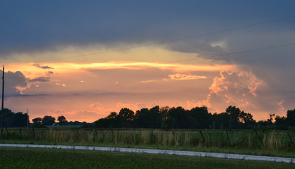 Sunset Over the Farm, Surrounded by Storm Clouds
