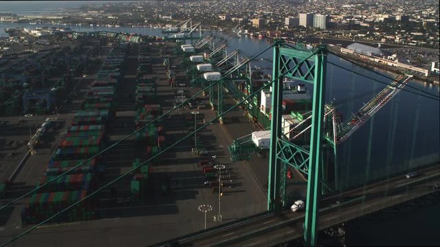 Flying over Vincent Thomas Bridge in Los Angeles Harbor, container ship at dock. Shot in 2010.
