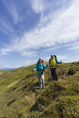 Summer hiking in the mountains with a backpack .