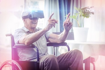 Happy senior man on wheelchair using VR headset