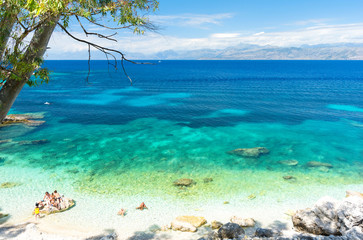 Fototapeta na wymiar amazing beach with crystal clear water in Kassiopi in Corfu island, Greece