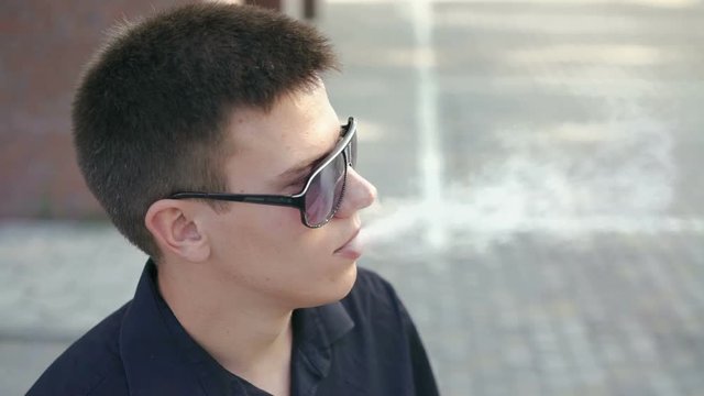 Profile of young man smoking an e-cigarette