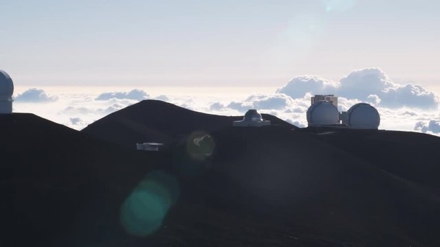 Mauna Loa Observatory with lens flares and a sea of clouds. Shot in 2010.