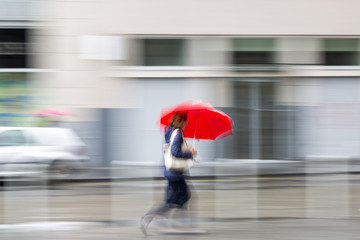 Blurred woman in the city, zoom effect, motion blur