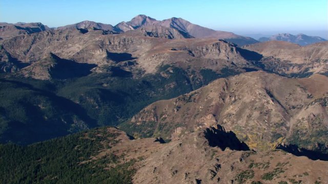 Wide aerial view of barren, brown mountains in Colorado. Shot in 2003.
