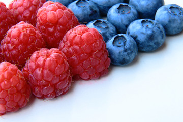 closeup of a bunch of raspberries and blueberries