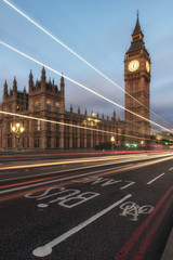 Obraz premium Big Ben, one of the most prominent symbols of both London and England, as shown at night along with the lights of the cars passing 