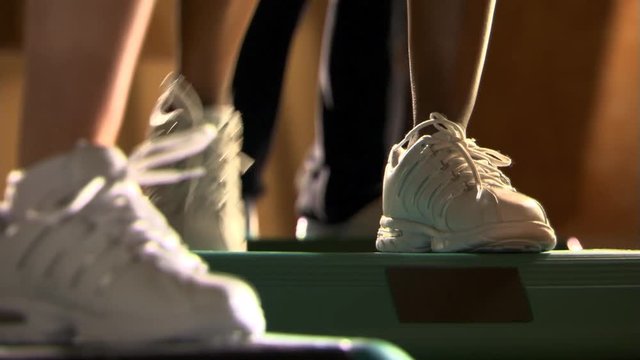 Close-up feet of women participating in a step-aerobics class