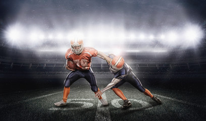 Fototapeta na wymiar Young american football players in action on stadium with ball