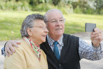 elderly couple doing selfie