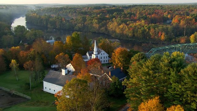 Flying over Maine village in autumn