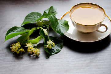 porcelain Cup of Linden tea on a background of dark wood