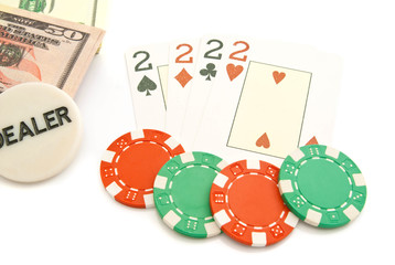 four playing cards, dollars and chips