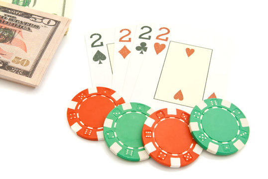 four playing cards, dollars and plastic chips
