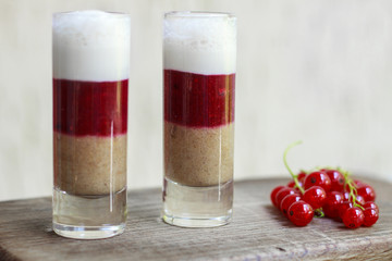 milkshake with a currant and raspberry. Cocktail layers on the w
