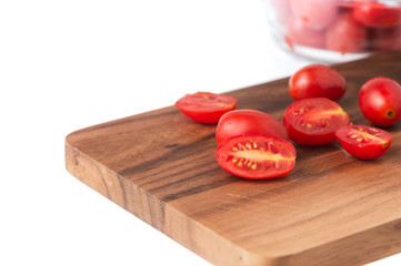 fresh tomato on wood plate.