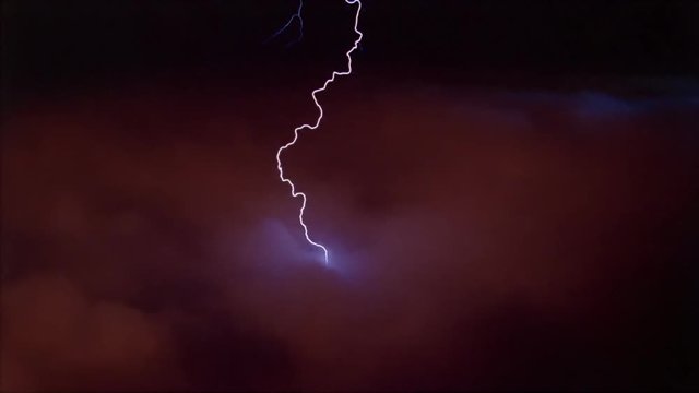 Lightning effects striking down into red clouds