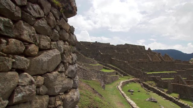 Machu Picchu, Peru: Pan from rock wall to Eastern Urban Center