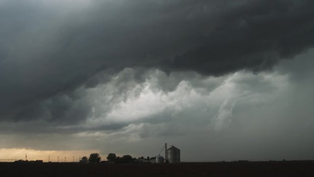 Threatening time-lapse storm clouds over a grain silo