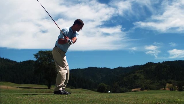 Ultra-slow motion shot of golfer teeing off