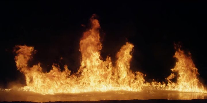 Flames burning on a lake of liquid fuel gradually subside