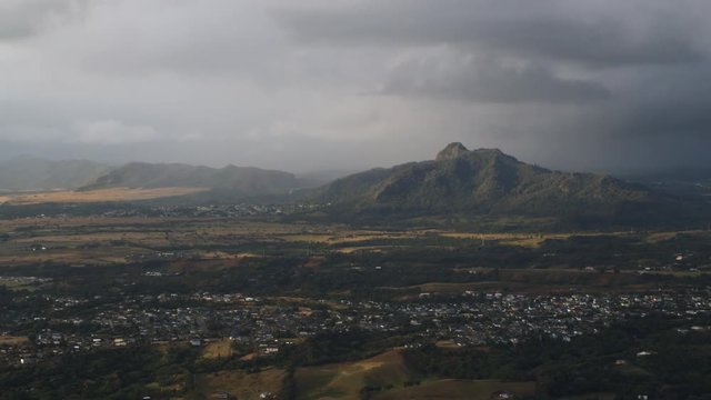 Past Kapaa, Hawaii, under rain clouds. Shot in 2010.