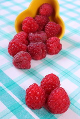Fresh raspberries on checkered tablecloth, healthy food