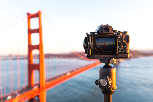 camera with gold gate bridge over water