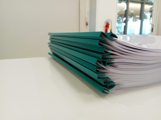 Green document folders on white desk