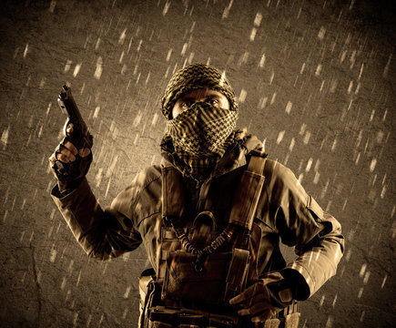 Dangerous heavily armed terrorist soldier with mask on grungy ra