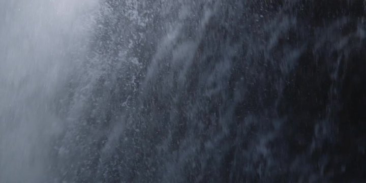 Rapid tilt-down from rim of waterfall to close-up plunging water